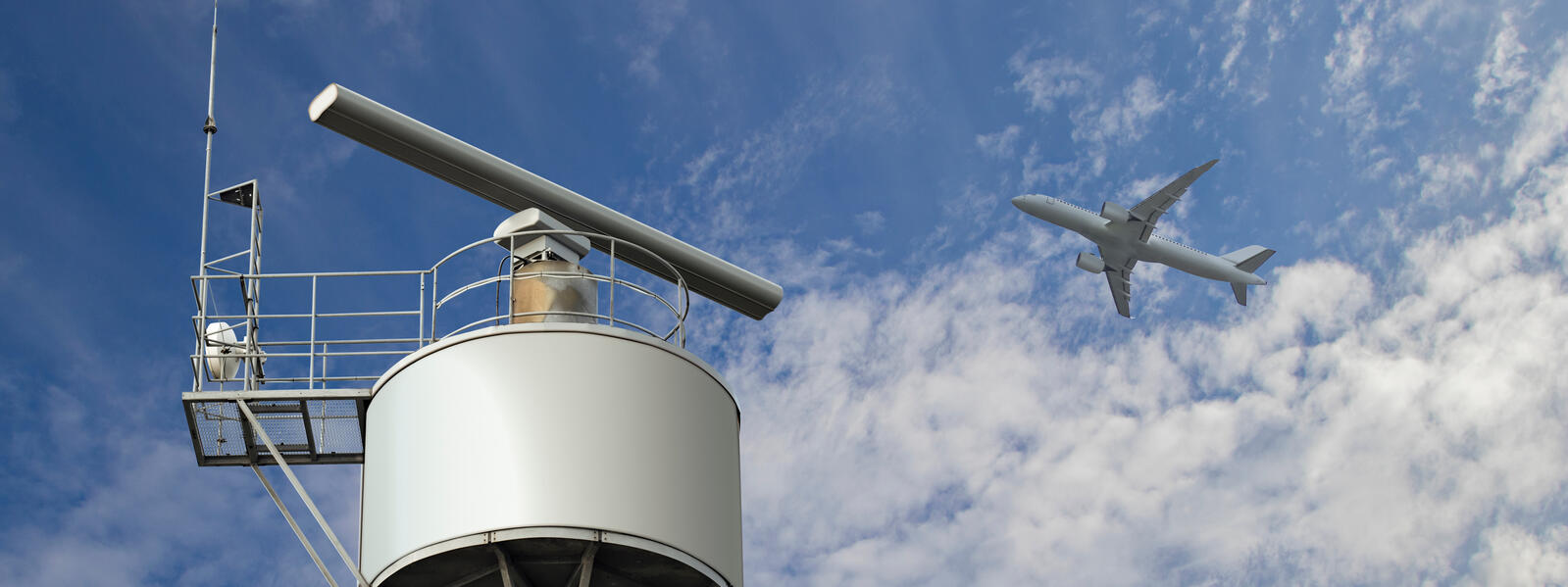 Rotating radar with plane in sky in background